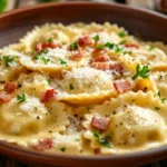 Creamy Ravioli Carbonara served with bacon and Parmesan.